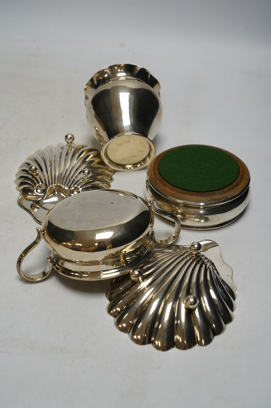 Sundry small silver including a pair of Edwardian butter shells, a vase, a later two handled shallow bowl and a modern wine coaster, 10.9oz. Condition - fair